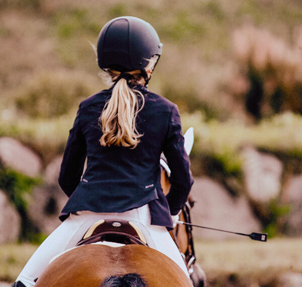 Back of child riding a horse